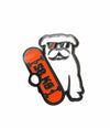 Closeup zoomed in black outlined white dog wearing black sunglasses with one red lens holding red skateboard with sbk9 black lettering in shiny enamel pin